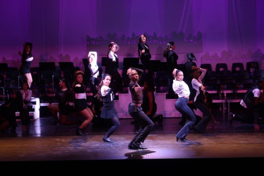  Dancers dressed in black and white tops and black pants 