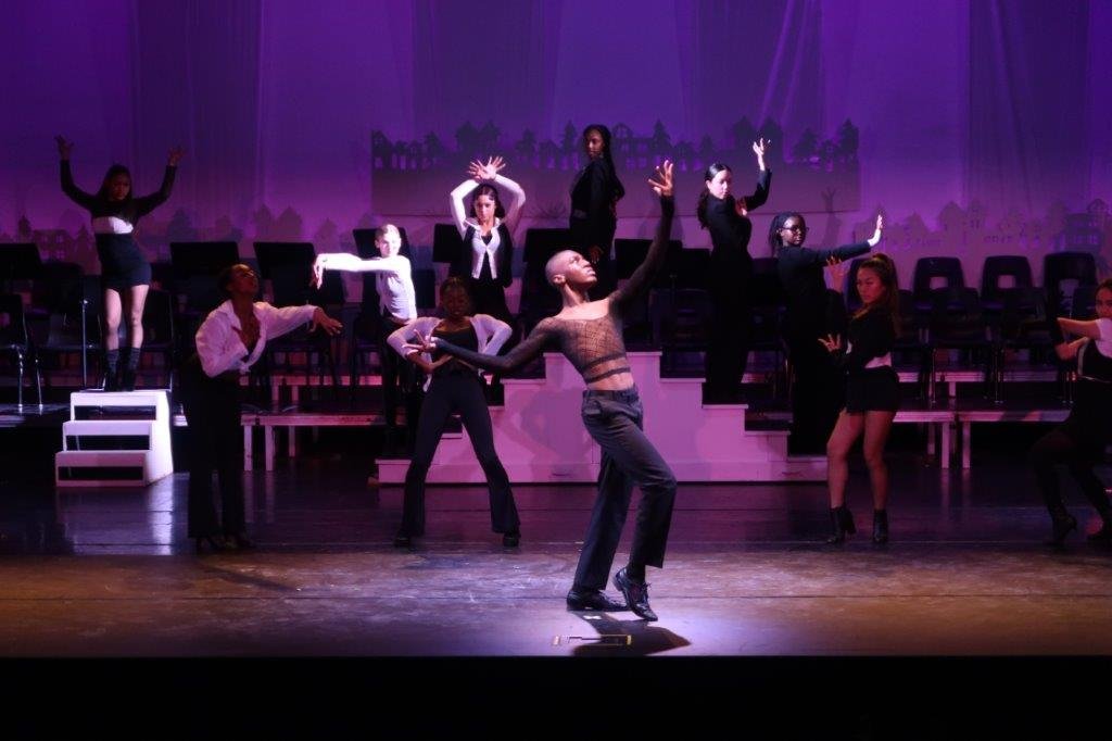  Dancers dressed in black and white tops and black pants 