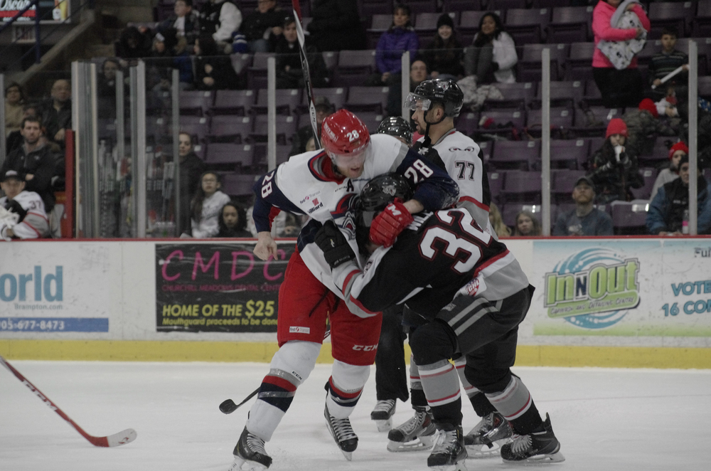  The Elimra Jackal's Andrew Conboy and the Brampton Beast's Cal Wild struggle in a fight at the Powerade Centre in Brampton, Ontario on January 25, 2015, which was a result of&nbsp;Conboy cross-checking Wild in the face. &nbsp;As published in Snapd B
