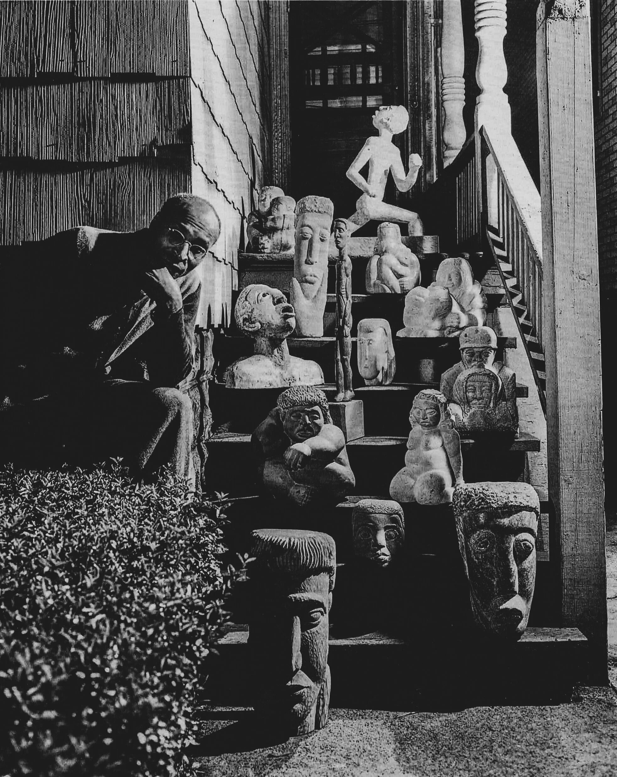 Marion Perkins at home,  alongside several of his sculptures.