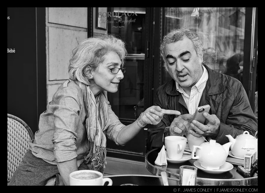 Sharing iPhone photos at a cafe in Paris.