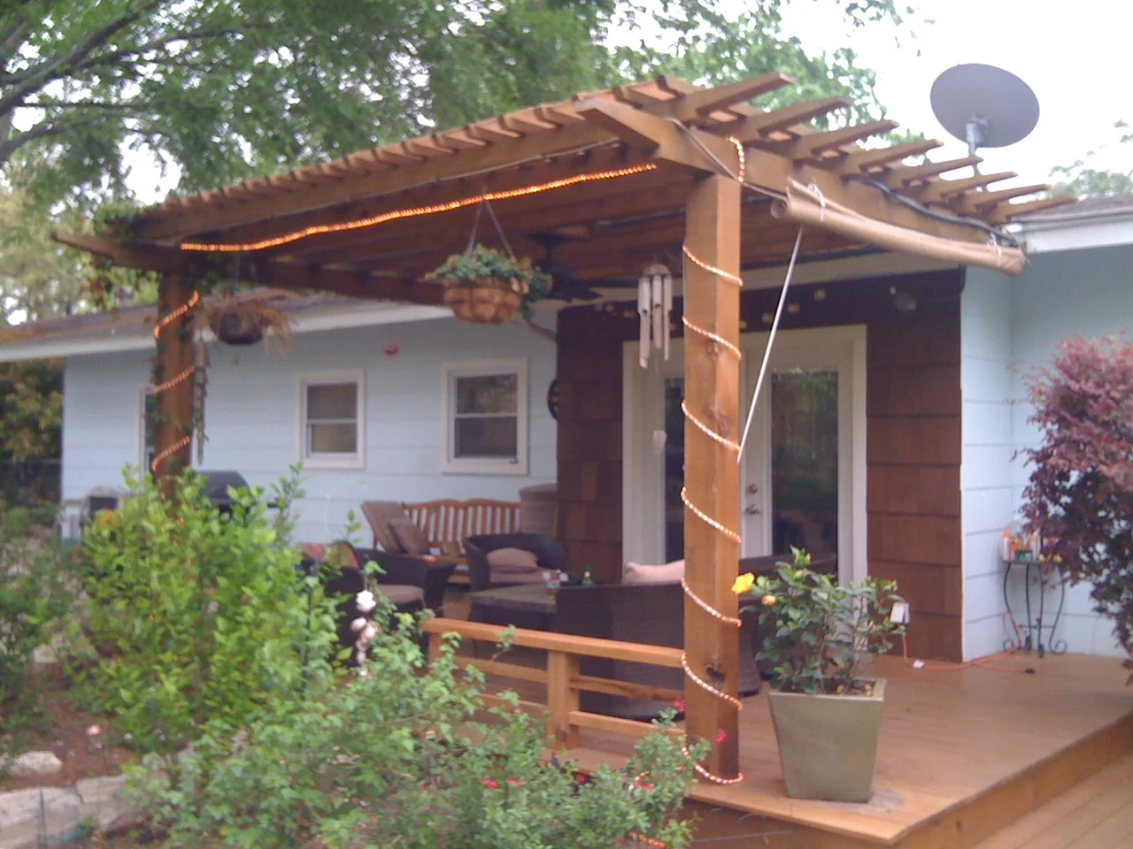 East Austin, TX: Cedar arbor tied to home over custom deck with bench railings and UV sunshade. Fan and misters created a screen of cooling water that repelled mosquitos without need for actual screens. 