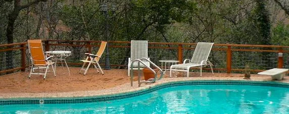  Invisible fencing behind pool is metal quarter panel tied into a cedar fence, minimizing the distraction from the beautiful greenbelt behind this Tarrytown, Austin, home. 