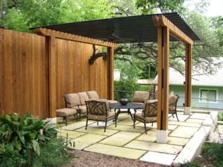 Cedar & metal arbor over flagstone patio, cedar wrapped metal posts with metal beams above.