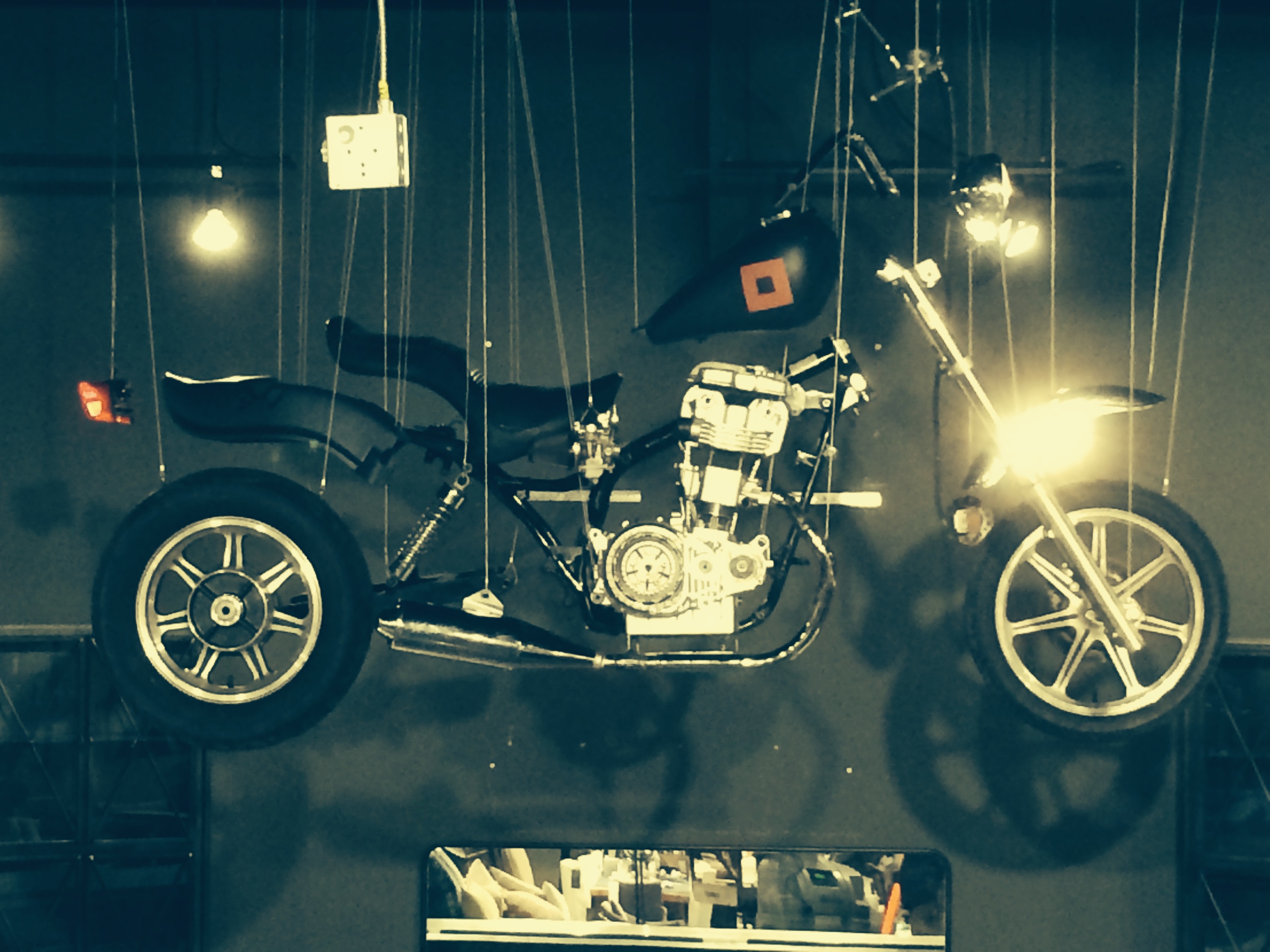Suspended disassembled motorcycle, Vegas Showroom 2014