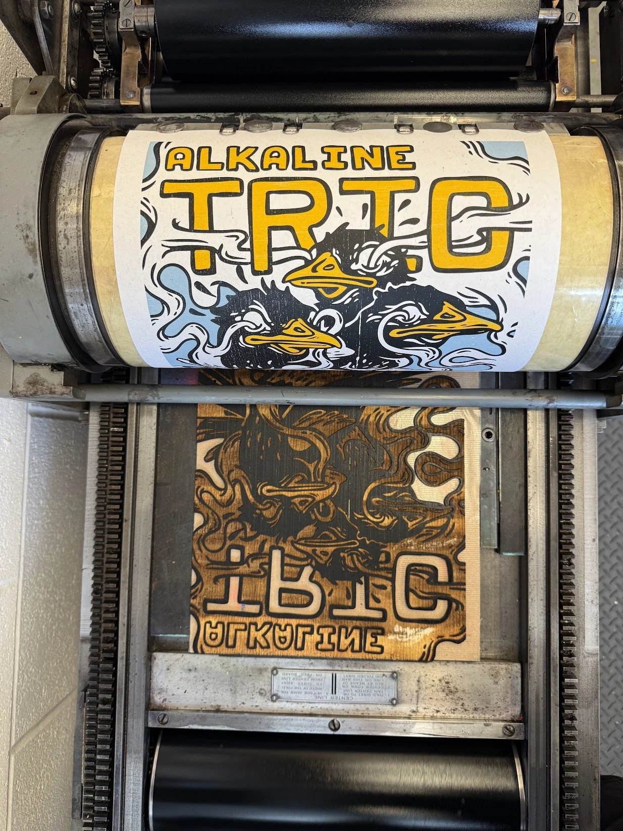 Hand-printed Alkaline Trio concert poster printing on a Vandercook No. 4 proof press using relief printing methods.