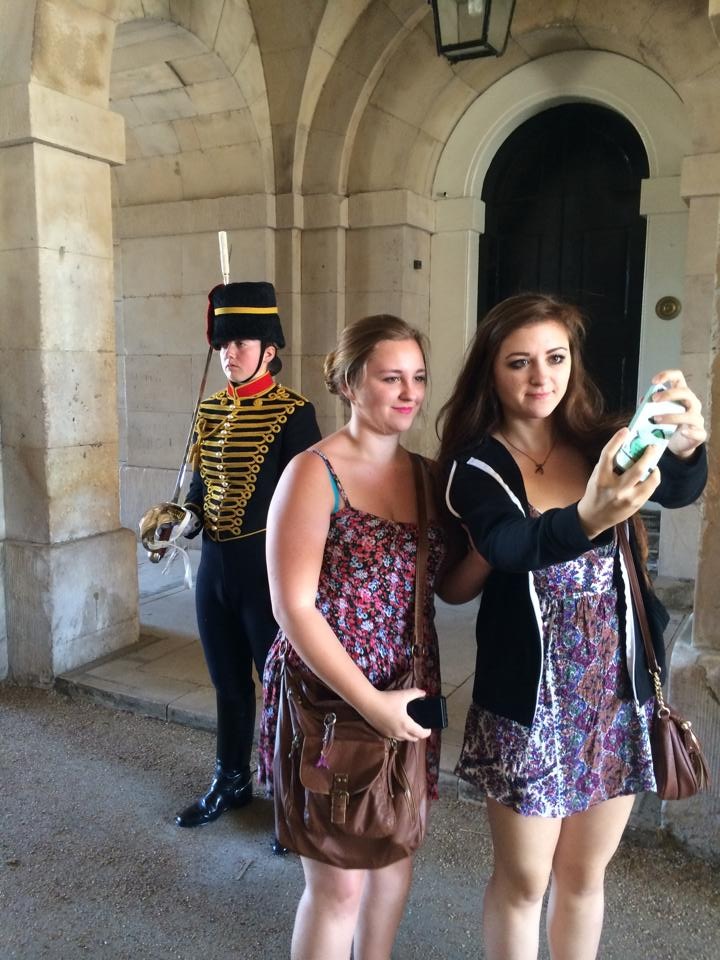 Monique's daughters taking a selfie with a Buckingham Palace guard