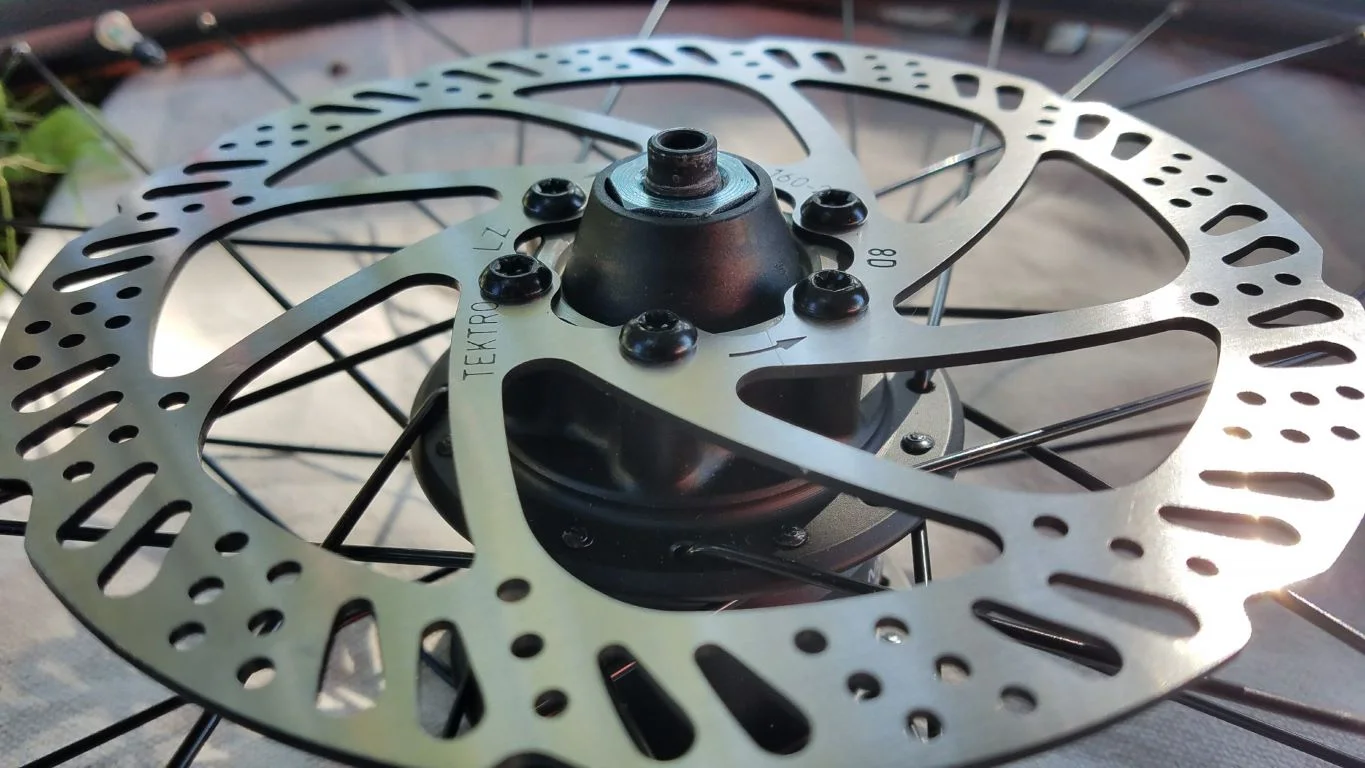 Take note of the directional arrows indicating the direction of rotation on the disk rotor. I tightened the rotor bolts in a star pattern, and torqued each bolt to 7 newton-meters.