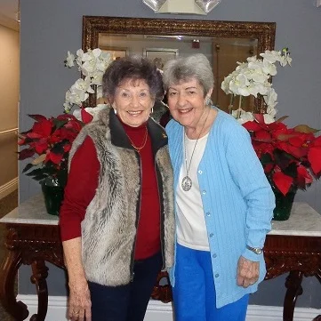 IPOC President Freeda Koopmans delivers poinsettias to Cambridge Assisted Facility