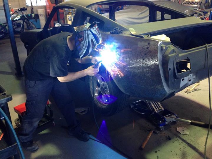 Welding up holes left by previous repairers.