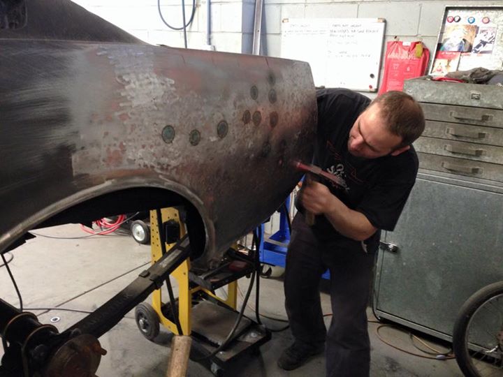 Roland shrinks the metal with a torch to get rid of some bulges left by the previous repairers.
