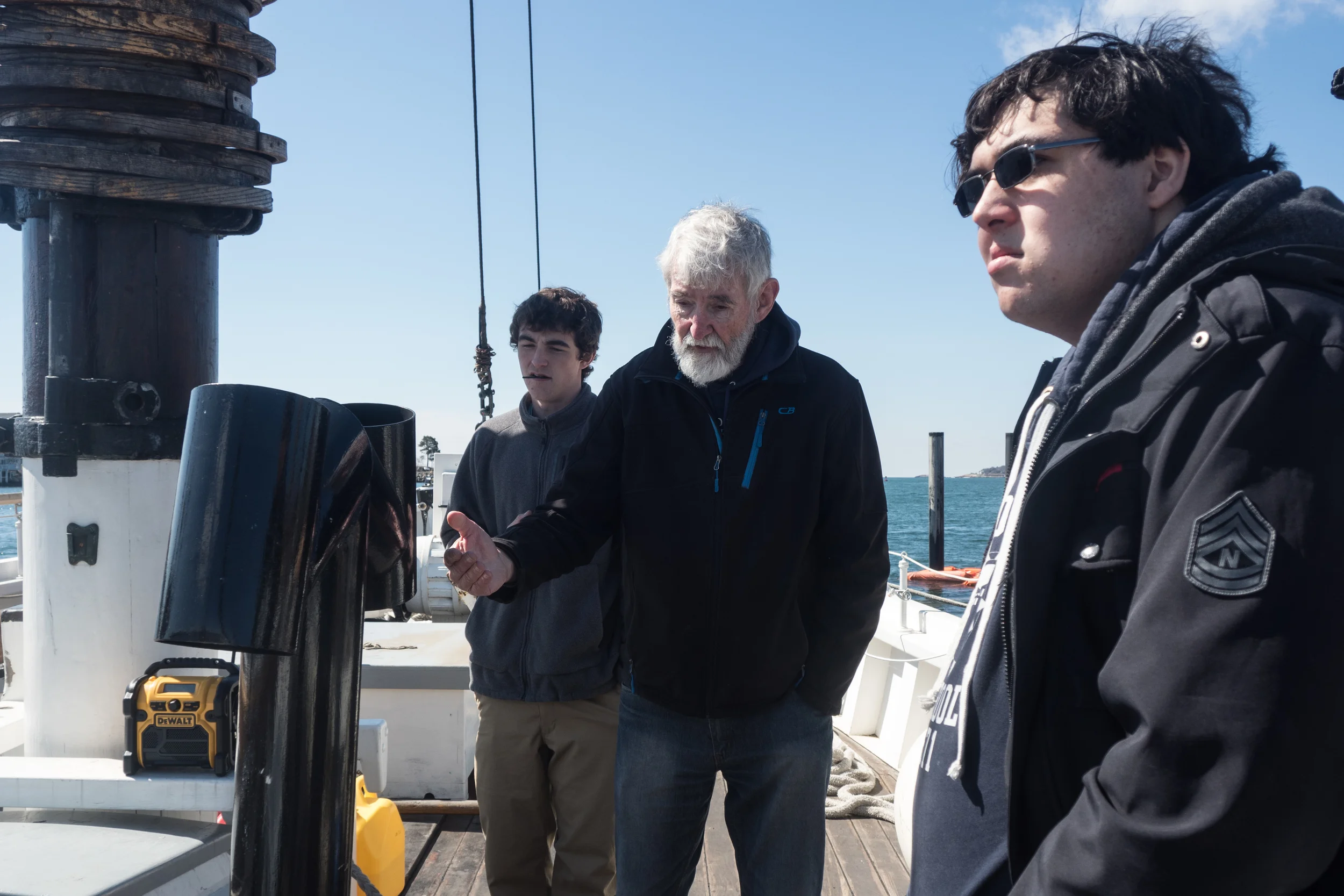   Mark, long time volunteer and sailor giving a tour to two local high schoolers on the Adventure. Tourists and locals often come down to check on the progress and tell stories of the schooner‘s previous fishing life they remember from childhood.  