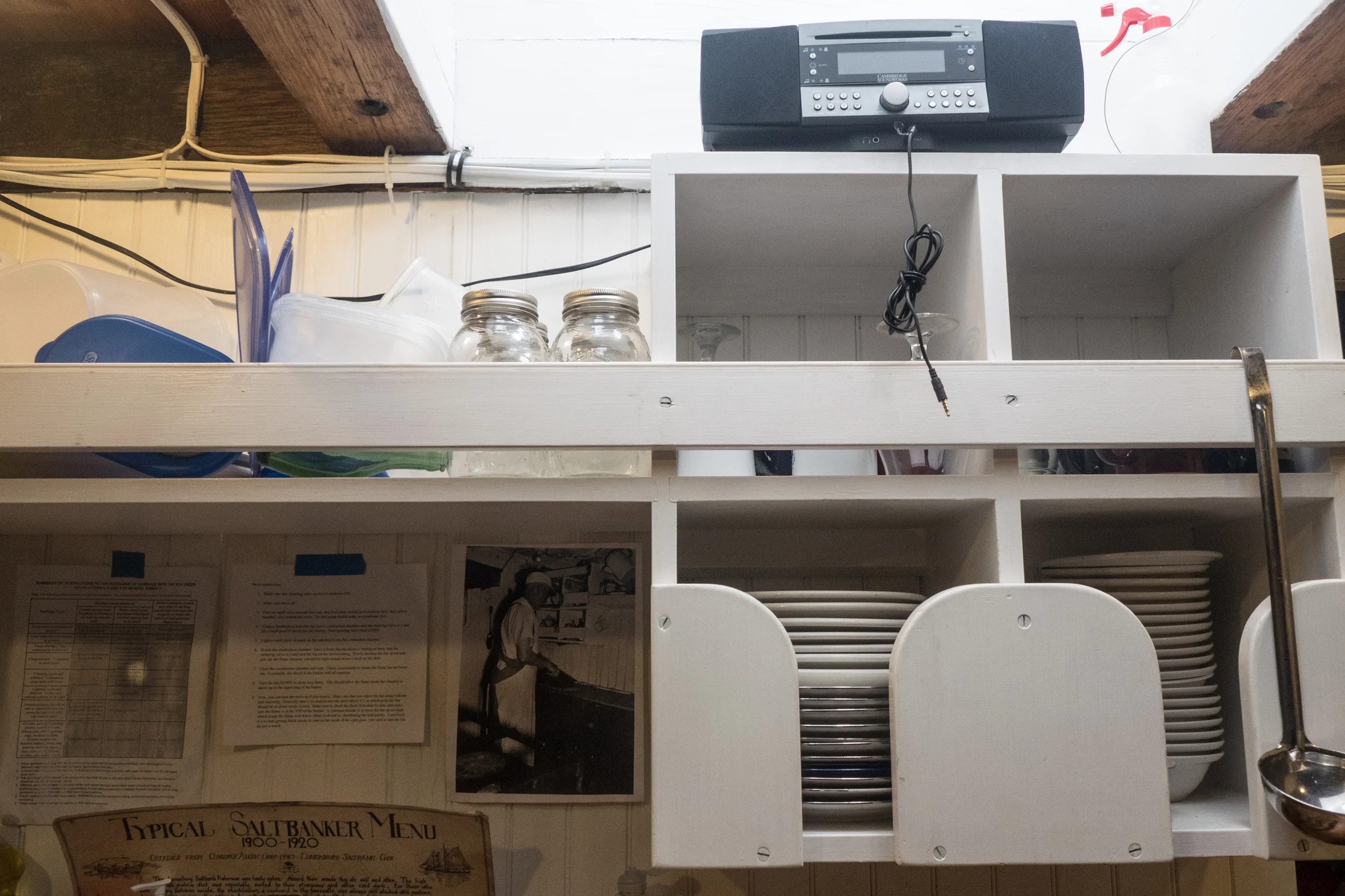   The kitchen interior down in the galley of the Adventure, black and white picture is from the 1950‘s. The Adventure crew is trying to restore not only how the schooner would sail but also how it would have looked, accurate down to the kitchen area,