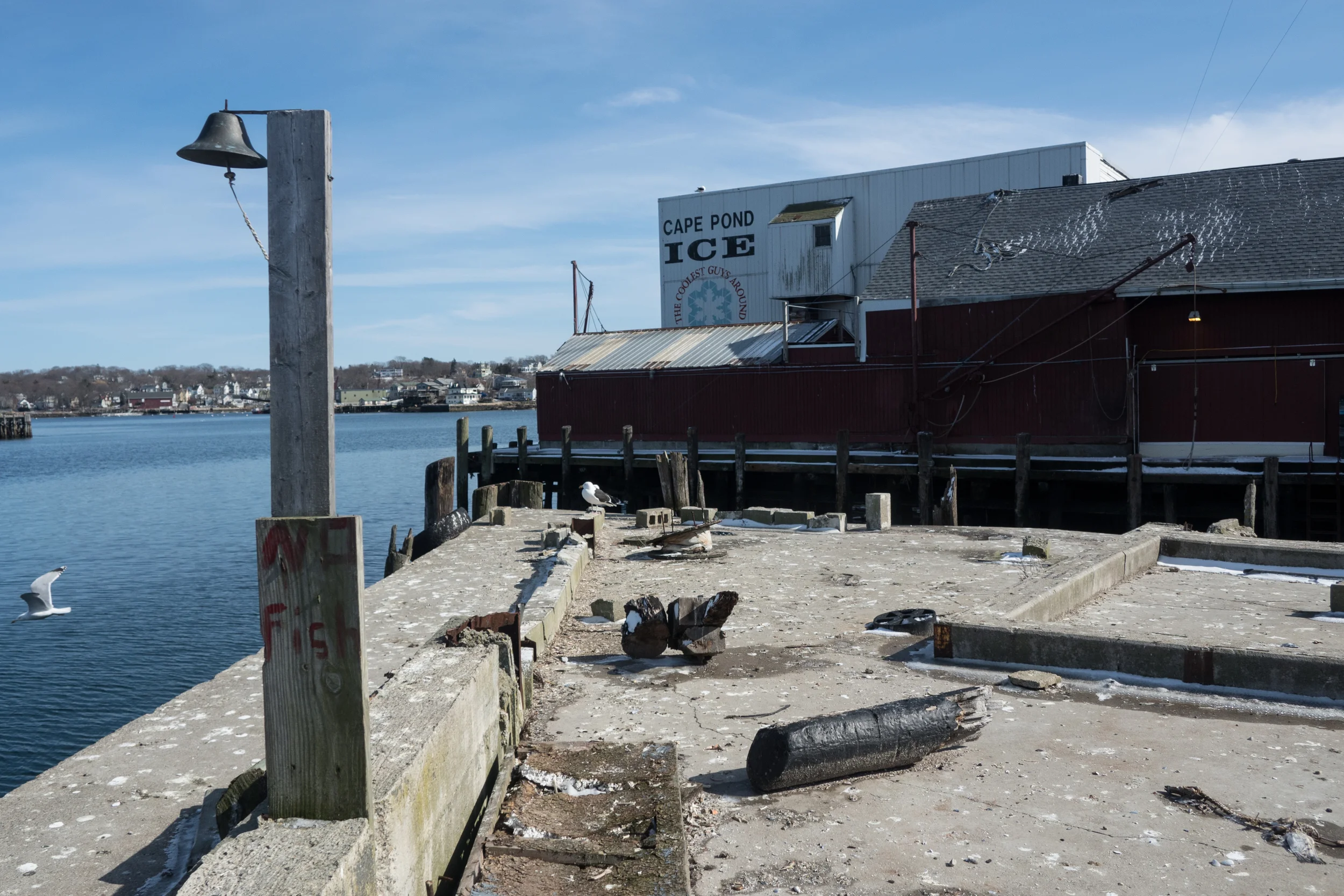   End of the Felicia Oil docks on Commercial street in Gloucester. In the mid to late 20th century, most city docks would have large boats stacked three or four across, now the fleet has been reduced significantly, similar grafetti can be found aroun