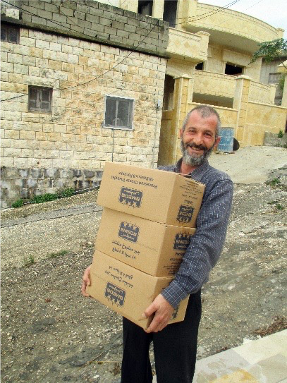 Bassam helps bring food to other displaced families whose heartbreak he understands only too well