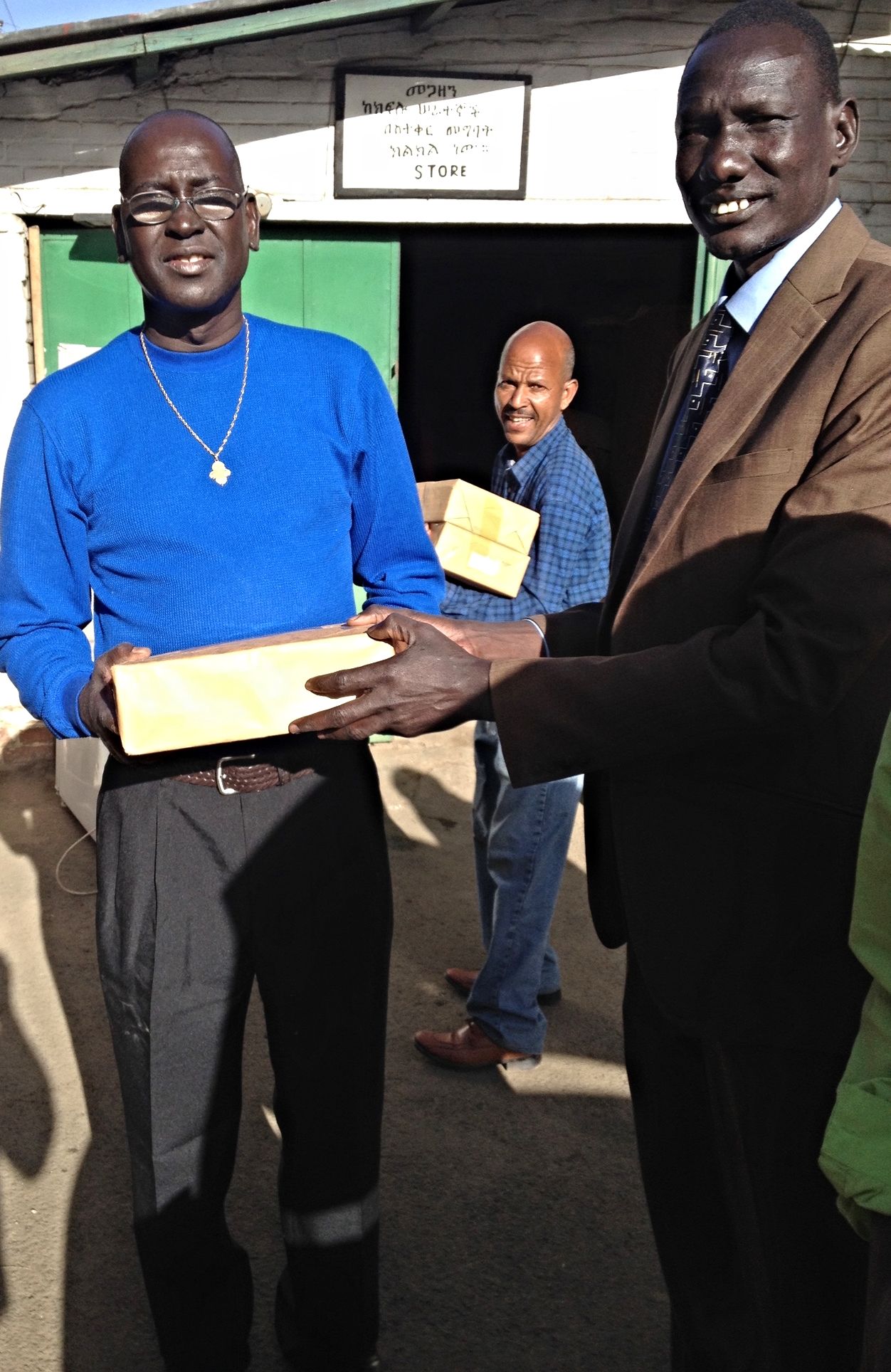 David Paduil and the Rev. Nhial loading hymnals to take to Gambella.