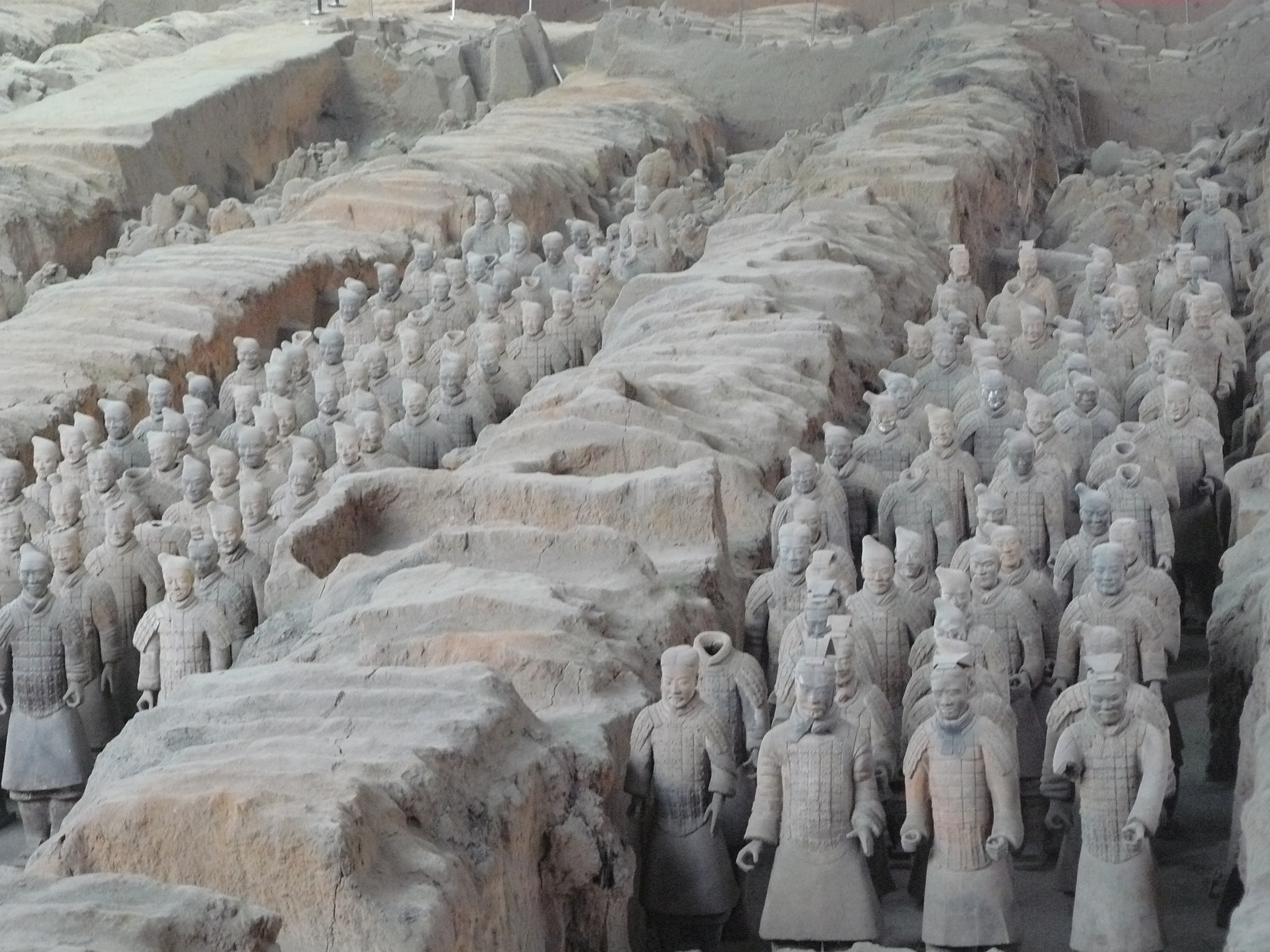 Ancient life-size terracotta warriors lined up to protect the emperor