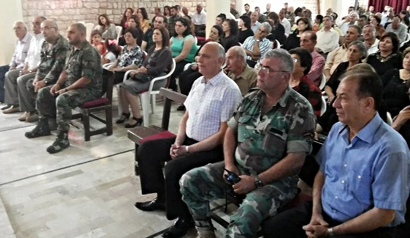 The congregation of Mhardeh gathers for worship. Some of its members are serving in the local National Guard.