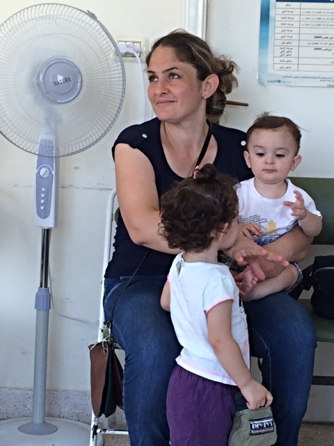 Marsen from the Ninevah plain in Iraq with two of her five children.