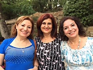 Ghada from Damascus flanked by her sisters-in-law.