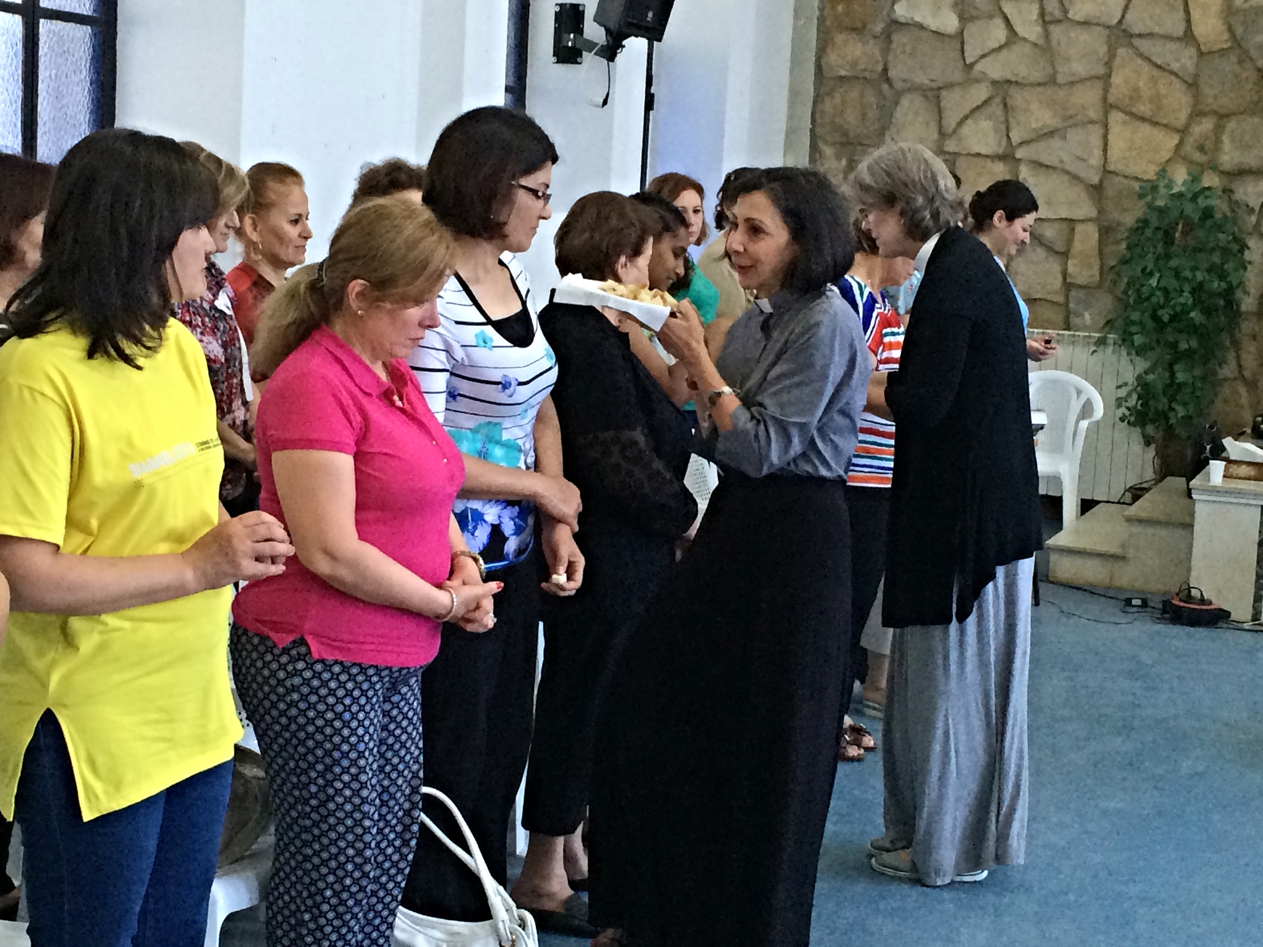 Lisa and Toby serve the elements to the women at the conference. Wafa, wife of the pastor from the Damascus church, is in the pink top.