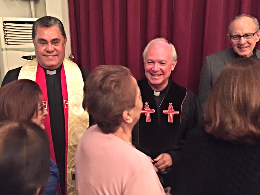Three assises in the receiving line after worship: Butros Zaour, Damascus; Jack Baca, Rancho Santa Fe, CA.; Rob Weingartner, The Outreach Foundation