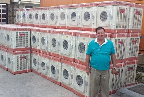 Rev. Haitham in his church's courtyard – now the staging area to distribute these portable A/C units
