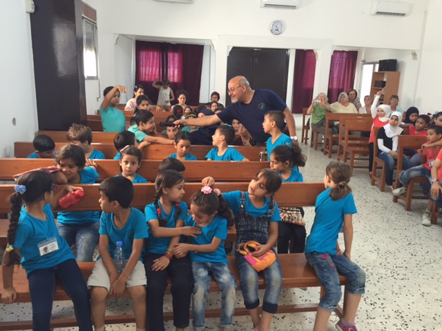 Rev. Amir engages the children in stories of the Bible