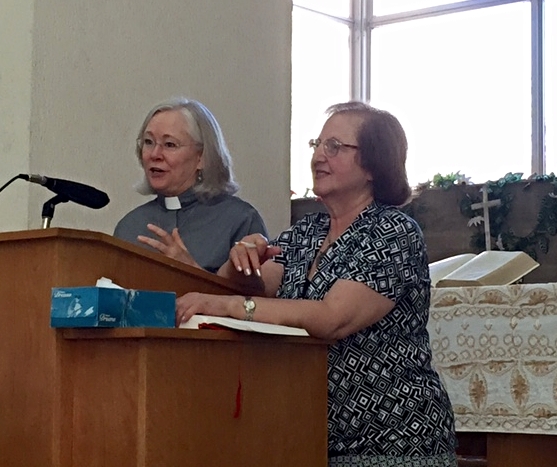Rev. Dr. Nancy Fox preaching, with Dr. Mary Mary Mikhael translating