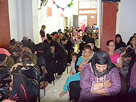 Women praying at their weekly women's meeting
