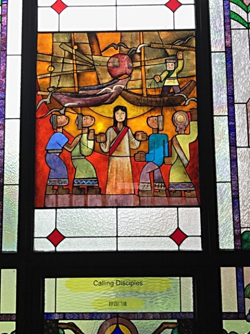 Stained glass from inside Dushu Lake Church. It incorporates the colors and designs from some of the Chinese minority ethnic groups to portray the ecumenical nature of the gospel. 