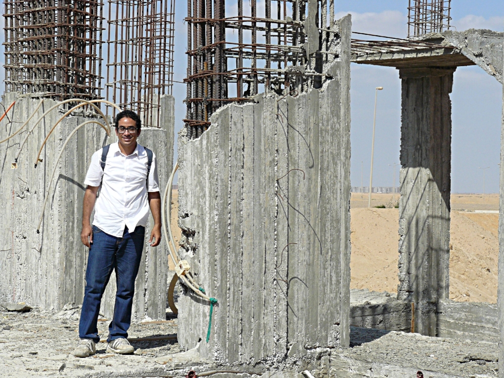 "Amir” standing in the new church, awaiting funds to continue construction .