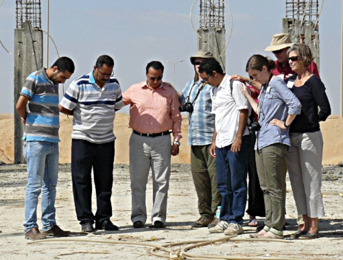 2016 Outreach team prays with Rev. (soon to be) Medhat, fourth from right, standing in his land grant church (El Sadat City Church) under construction.