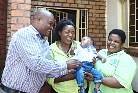 Kevin Jr. with the Mabwes on the left and the House of Moses house mother on the right.
