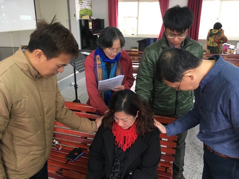 Pastors praying for one another at the retreat.