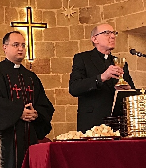 Outreach Executive Director Rob Weingartner (r) serving communion at the Latakia Church with Rev. Salam Hanna, pastor of the church, assisting.