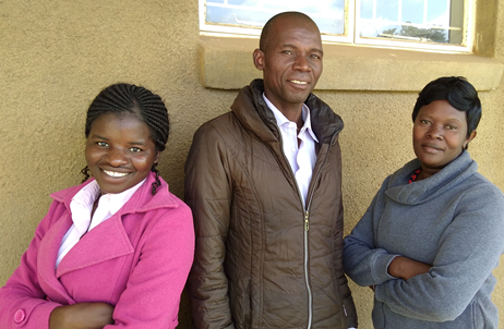 Justo Mwale students Naele Mawere, Feston Chilumpha, and Agness Nyondo-Nyirenda posing outside their thesis advisor's office.