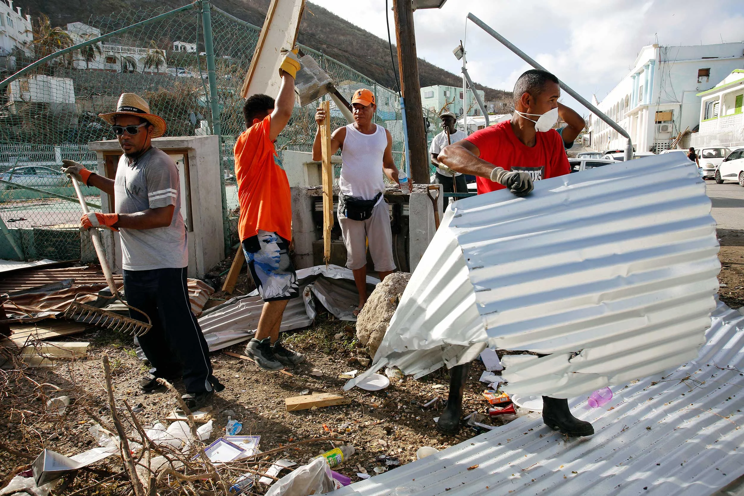 Workers clear debris on St Maarten ( photo by Arie Kievit for The Climate Centre )