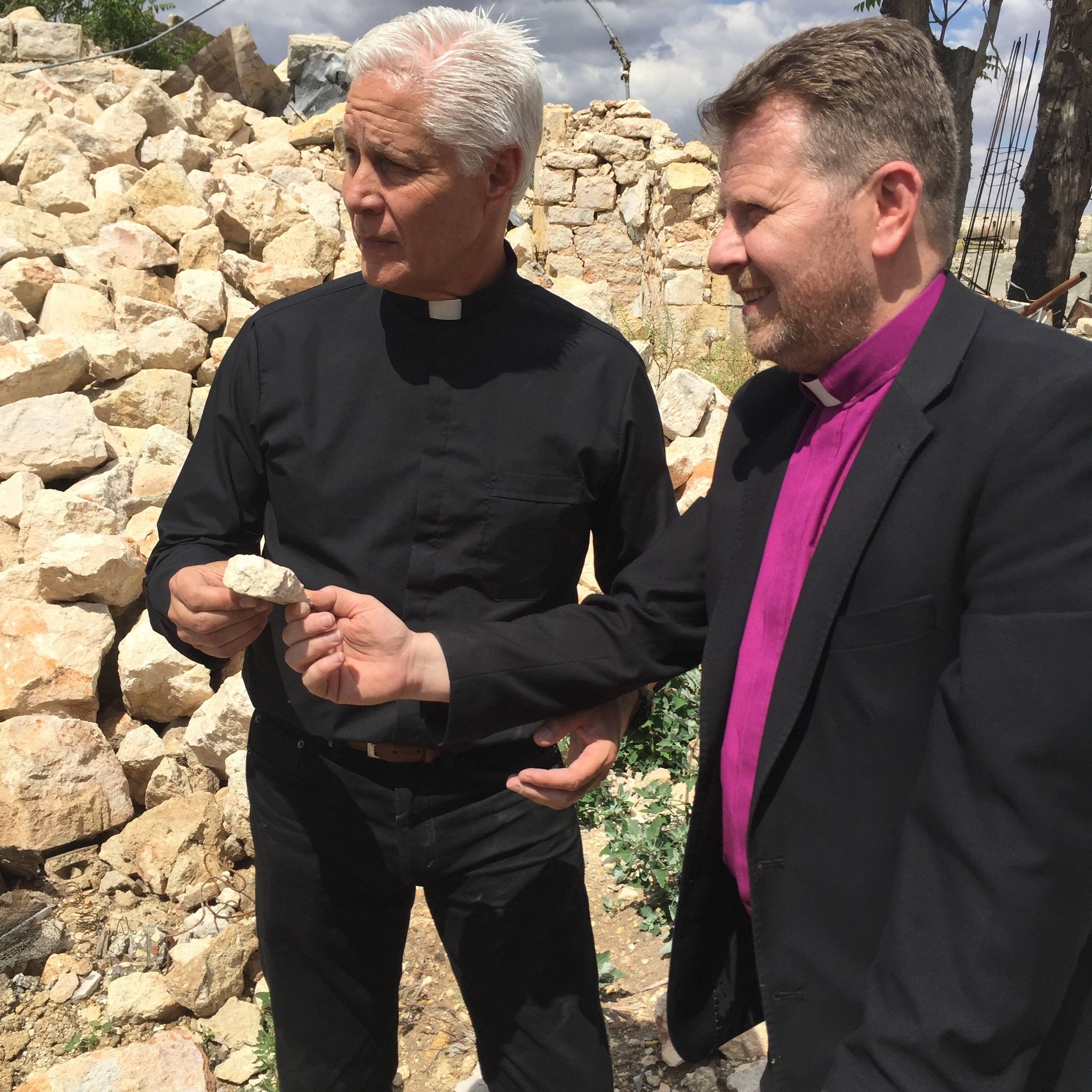 Rev. Jim Wood receives a stone of the old Aleppo church from Rev. Ibrahim.