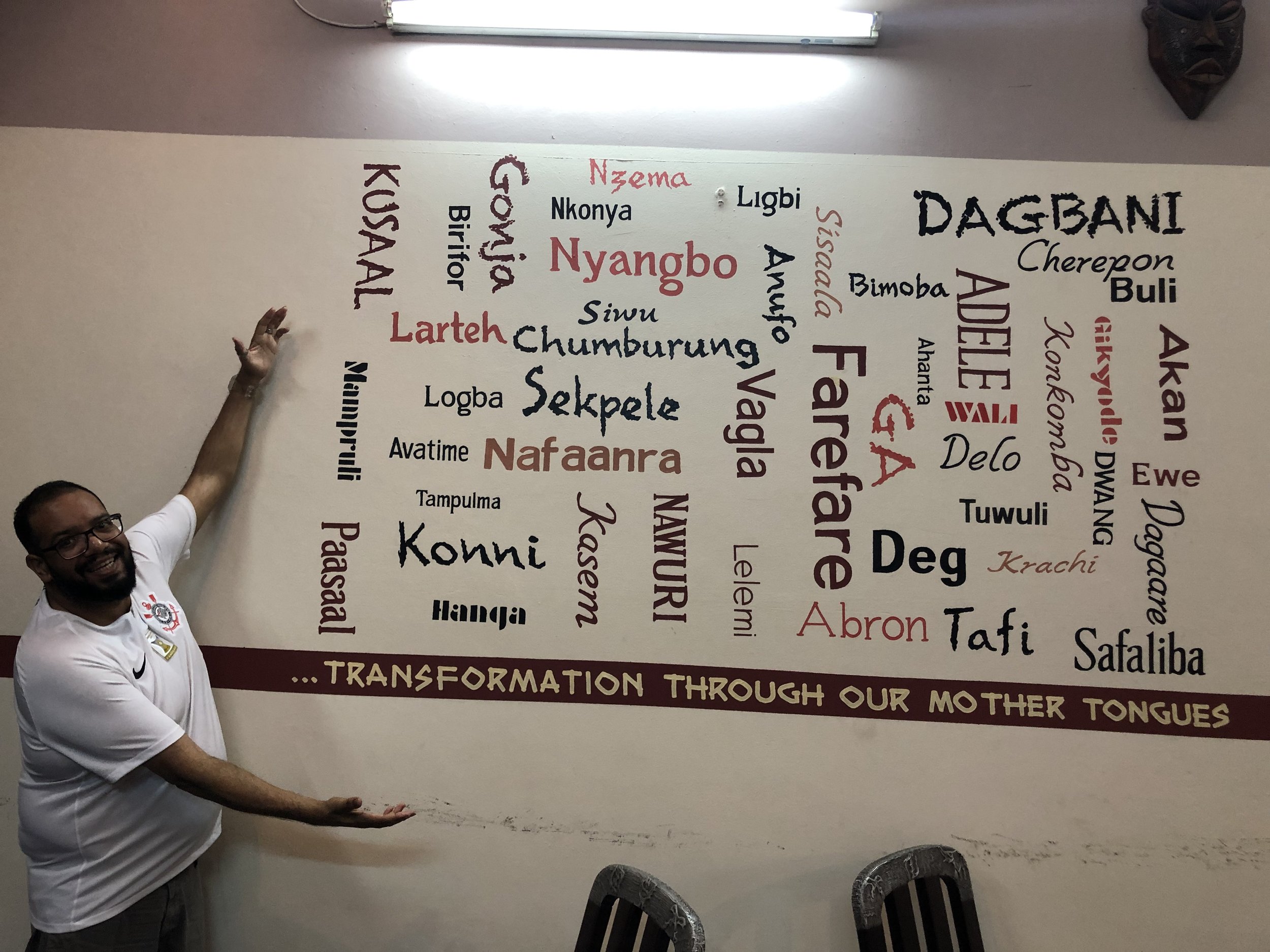  William Ramos at the Linguistic Institute of Ghana by a display of some of the languages in the country 