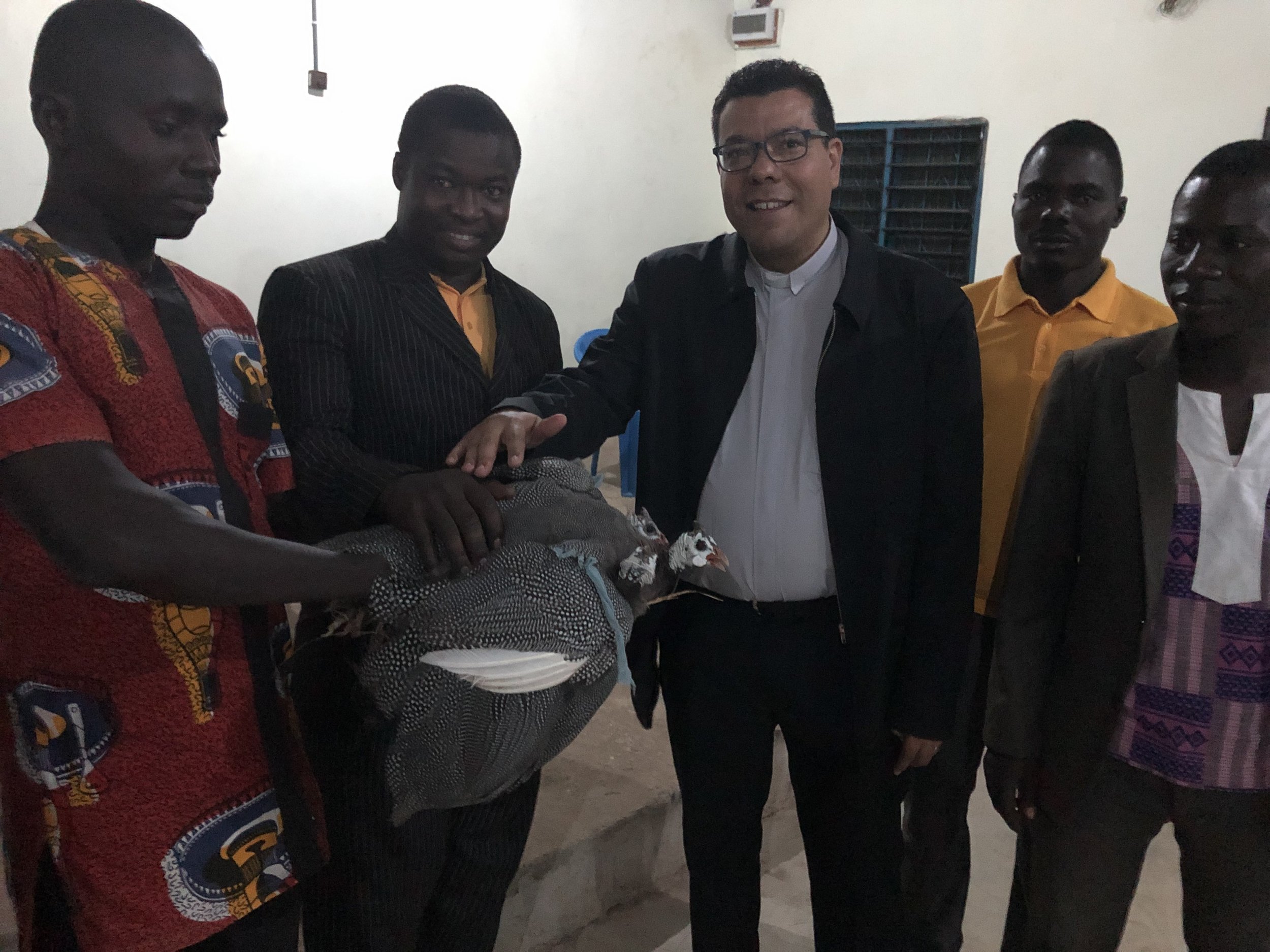  After worship at a church in Bawku presents Juan with two guinea fowl  