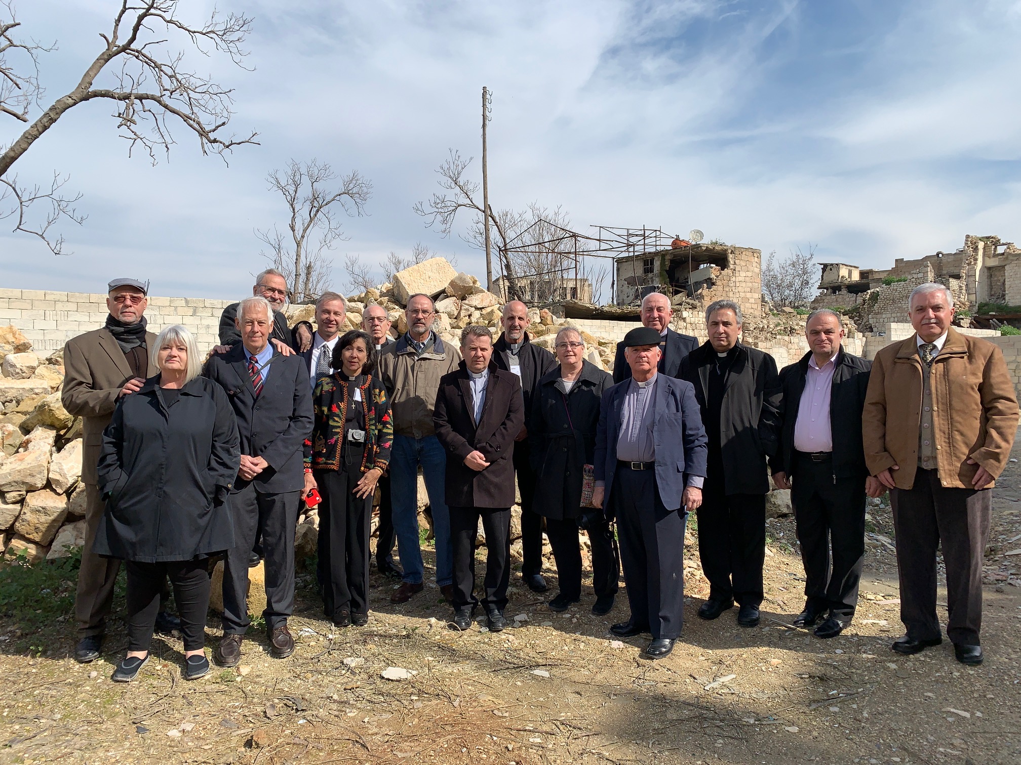  Outreach team with Rev. Nseir and elders of the Aleppo church standing in the rubble of the original church destroyed in November, 2012 