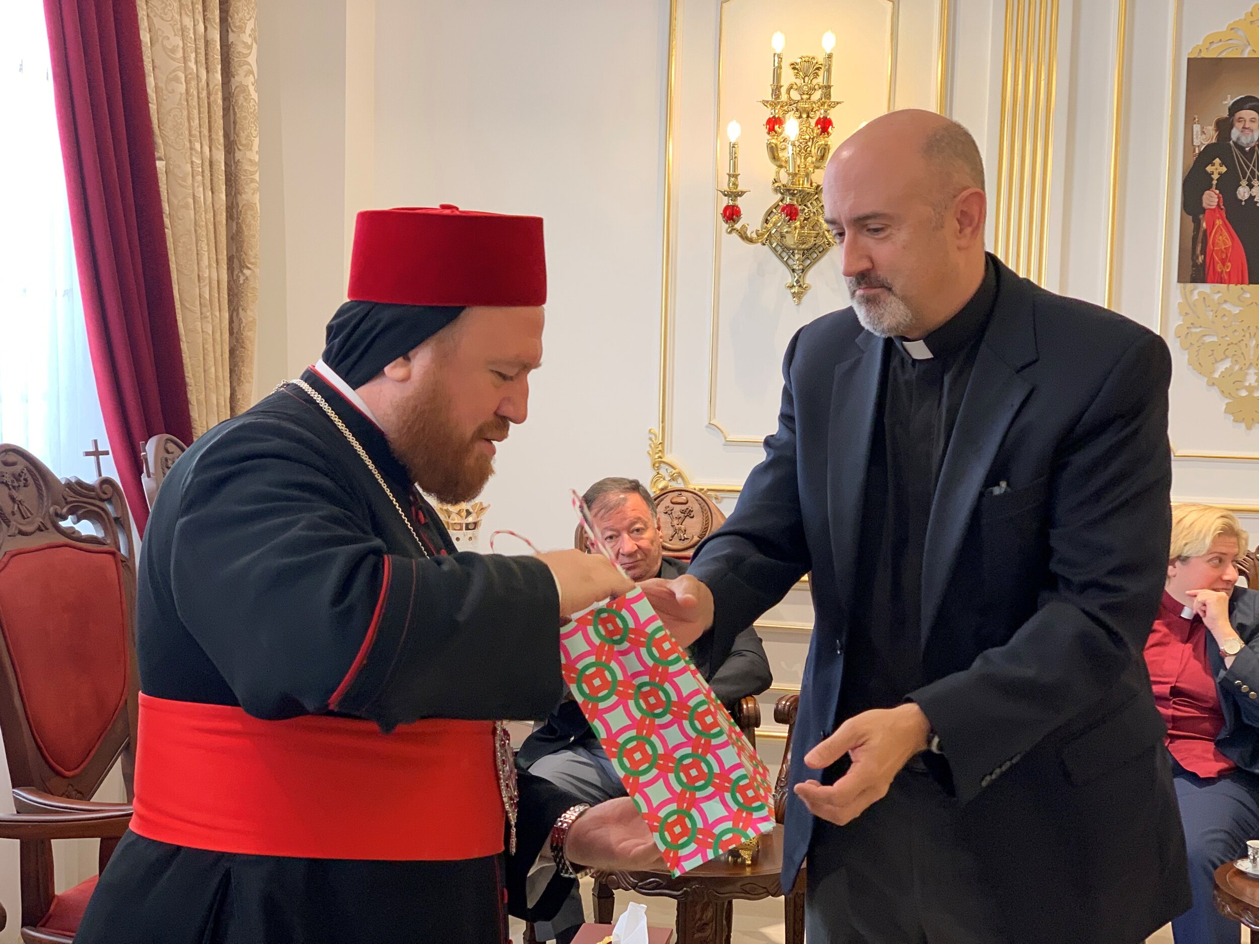  Chris Weichman presents the Archbishop with a cross, the symbol of our unity in Christ 