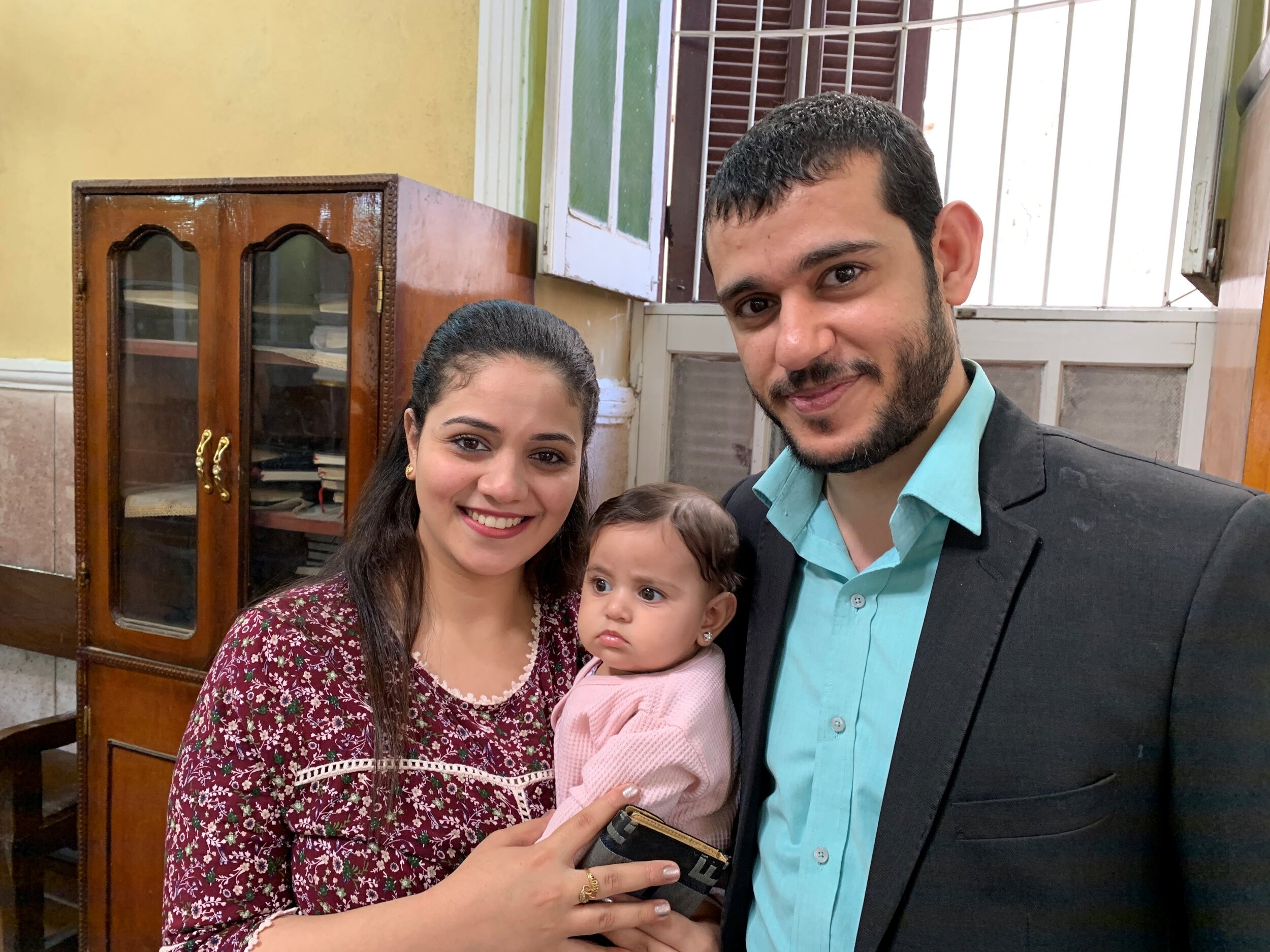  Rev. Medhet Zakhary with his wife of one year, Nosa, and their daughter, Loujean 