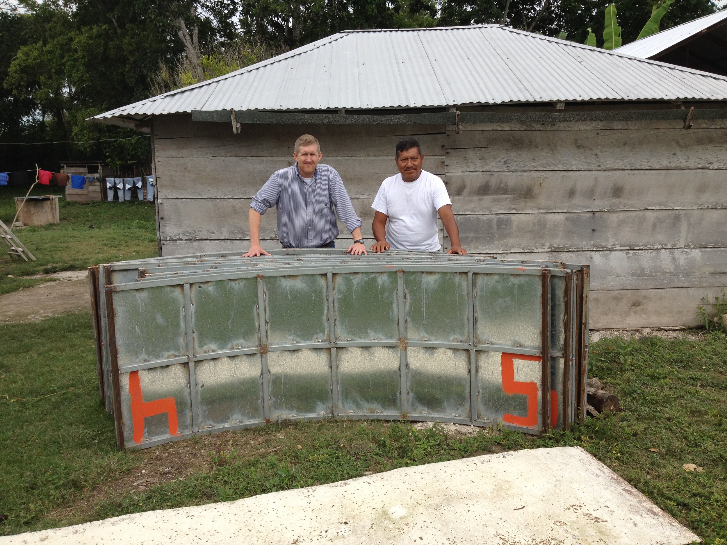 Todd and Maria Luke January 2015 update Victor Guzman and Todd standing behind part of a cistern mold.  Victor is one of his closest partners in the cistern ministry. They work together very closely..JPG