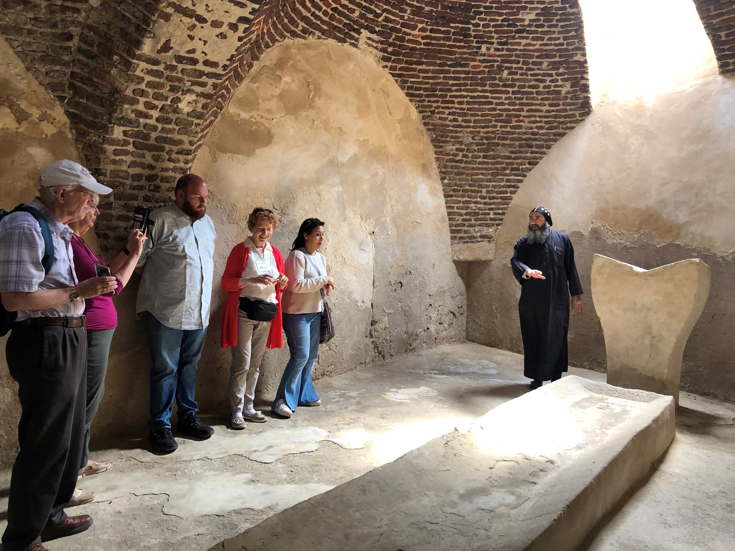  Brother Mercurios shows the historical refectory and lectern to the team at Macarios Monastery 