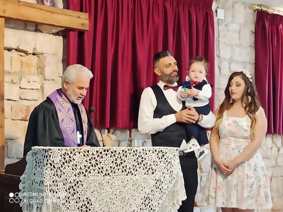   Rev Ma'an Bitar baptizes little Aziz on Oct 18 in the Presbyterian Church of Mhardeh, Syria  