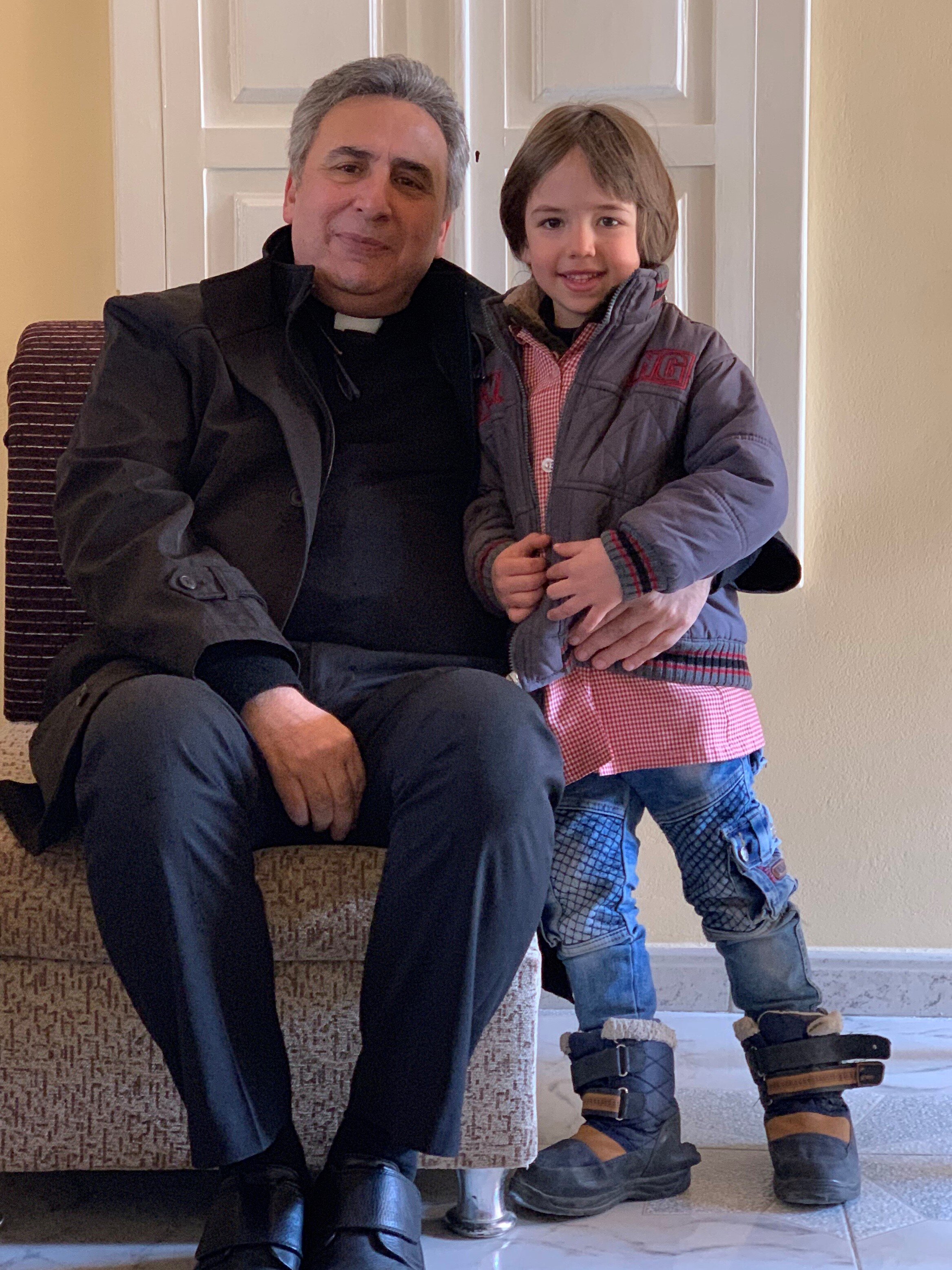  Rev. Joseph Kassab with a child named Christian whose parents are members of the church in Nabek, Syria 