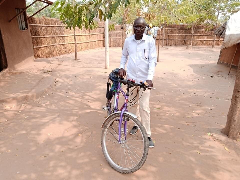 John Jock with bike provided by Outreach