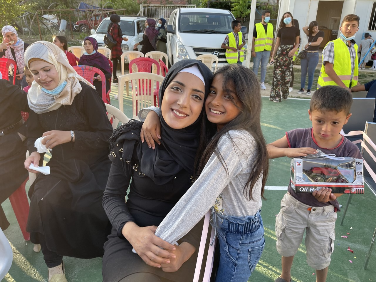  At the graduation, a refugee mother and daughter beam happiness and Hope, even for this brief moment  